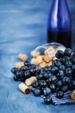 Branch of purple grape and wine corks on gray Royalty Free Stock Images Branch of purple grape and wine corks on gray Royalty Free Stock Images