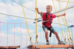 Brave Blond Hair Kid Playing Rope Course Outdoor Royalty Free Stock Images Brave Blond Hair Kid Playing Rope Course Outdoor Royalty Free Stock Images