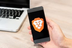 Brave Browser logo displayed on smartphone and computer laptop in background. Slovenia 13.02.2019 royalty free stock photo Brave Browser logo displayed on smartphone and computer laptop in background. Slovenia 13.02.2019 royalty free stock photo