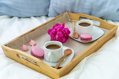 Breakfast in bed for two. Wooden tray with coffee, macaroons and Bizet. royalty free stock photo Breakfast in bed for two. Wooden tray with coffee, macaroons and Bizet. royalty free stock photo