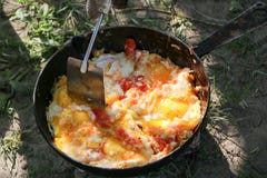 Scrambled egg fried on coals in pan on open fire, cook over an open fire Royalty Free Stock Photo Scrambled egg fried on coals in pan on open fire, cook over an open fire Royalty Free Stock Photo