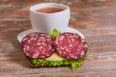 Breakfast With Salami Sandwich And Cup Of Tea Royalty Free Stock Images