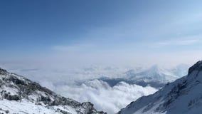 Breathtaking view of mountains and volcanoes from a height of 3900 meters. Higher than clouds.
