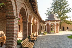 Brick arcades, wood benches in exterior court of Plumbuita Monastery, Bucharest, Romania Royalty Free Stock Photos Brick arcades, wood benches in exterior court of Plumbuita Monastery, Bucharest, Romania Royalty Free Stock Photos