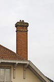 Brick Chimney On Tiled Roof Stock Photos