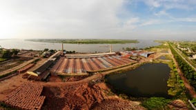 Brick production village stretches along the river bank stock image Brick production village stretches along the river bank stock image