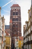 Brick tower of Basilica Assumption Blessed Virgin Mary St Marys Church Cathedral view from narrow street with typical colorful royalty free stock photos Brick tower of Basilica Assumption Blessed Virgin Mary St Marys Church Cathedral view from narrow street with typical colorful royalty free stock photos
