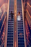 Bride and groom on escalators stock photography Bride and groom on escalators stock photography