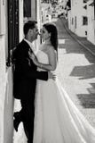 Bride and groom kissing in the street royalty free stock photo Bride and groom kissing in the street royalty free stock photo