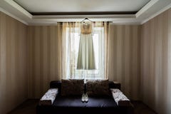 Bride`s dress hanging on rack near the window in the room stock image Bride`s dress hanging on rack near the window in the room stock image