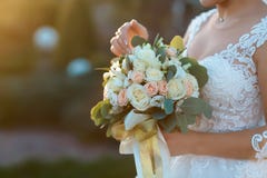 Bride showing off her beautiful boho flowers bouquet at sunset. Perfect image with copy space for: chic boho wedding magazines and royalty free stock photo Bride showing off her beautiful boho flowers bouquet at sunset. Perfect image with copy space for: chic boho wedding magazines and royalty free stock photo