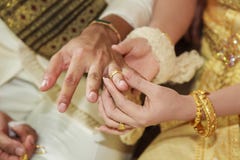 Bride wearing wedding ring for her groom hand Royalty Free Stock Photos Bride wearing wedding ring for her groom hand Royalty Free Stock Photos