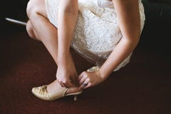Bride sitting and putting on shoes royalty free stock photo Bride sitting and putting on shoes royalty free stock photo