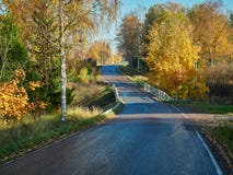 Bright fall colors and beautiful autumn country road in Finland stock photo Bright fall colors and beautiful autumn country road in Finland stock photo