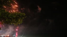 Firework in the sky. Bright firework in night sky on dark sea Firework in the sky. Bright firework in night sky on dark sea