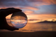 Bright Orange Sunset over Ocean Captured in Glass Ball royalty free stock photography Bright Orange Sunset over Ocean Captured in Glass Ball royalty free stock photography