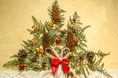Bright plywood with a Christmas tree,of twigs thuja with fir cones and chocolate on lace ribbon Royalty Free Stock Photography Bright plywood with a Christmas tree,of twigs thuja with fir cones and chocolate on lace ribbon Royalty Free Stock Photography