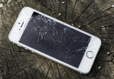 Broken iphone. Broken white iphone glass on wood Broken iphone. Broken white iphone glass on wood