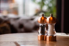 A bronze Salt and pepper shaker and grinder sit on a table inside a Irish restaurant stock images A bronze Salt and pepper shaker and grinder sit on a table inside a Irish restaurant stock images