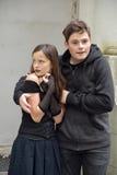 Cute teenager brother protects his afraid little sister stock image Cute teenager brother protects his afraid little sister stock image