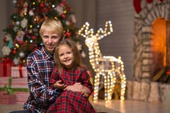 Brother and sister near the Christmas tree stock photos Brother and sister near the Christmas tree stock photos