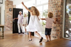 Brother and sister rush to meet their visiting grandparents royalty free stock photo Brother and sister rush to meet their visiting grandparents royalty free stock photo