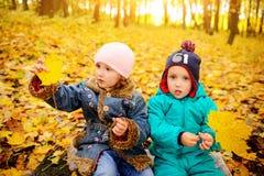 Brothers and sister playing outside in Autumn leaves. stock photos Brothers and sister playing outside in Autumn leaves. stock photos