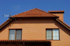 Brown Brick Attic With Windows Under A Tiled Roof With A Chimney Stock Images Brown Brick Attic With Windows Under A Tiled Roof With A Chimney Stock Images
