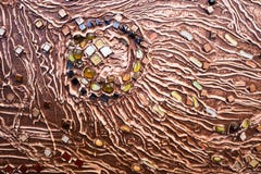 The brown texture of the concrete wall is made of decorative plaster with the addition of multi-colored gems, glass squares and ci stock image The brown texture of the concrete wall is made of decorative plaster with the addition of multi-colored gems, glass squares and ci stock image