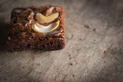 Brownie with topping Cashew putting on a wooden desk stock photos Brownie with topping Cashew putting on a wooden desk stock photos