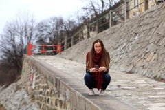 Brunette girl wearing leather jacket, blue jeans and pink sneakers royalty free stock image Brunette girl wearing leather jacket, blue jeans and pink sneakers royalty free stock image