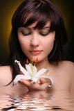 Brunette With White Lily Flowers In Water Stock Photo