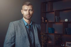 Brutal Stylish Man In Suit With Fashionable Hairdo In Luxurious Interior Of Apartment. Handsome Businessman In Rich House. Stock Images
