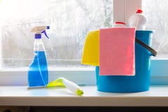 Bucket spray and squeegee for window cleaning on the window sill. stock photo Bucket spray and squeegee for window cleaning on the window sill. stock photo