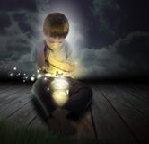 Bug Boy Child with Glowing Butterfly at Night stock images Bug Boy Child with Glowing Butterfly at Night stock images