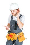 A builder or an employee in a protective helmet is listening. Is stock image A builder or an employee in a protective helmet is listening. Is stock image