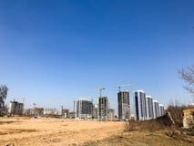 Building with the help of construction cranes of high reinforced concrete, panel, cast-frame, frame-block houses, buildings stock image Building with the help of construction cranes of high reinforced concrete, panel, cast-frame, frame-block houses, buildings stock image