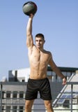 Built young sportsman. Exercise with a Grip Medicine Ball. royalty free stock photo Built young sportsman. Exercise with a Grip Medicine Ball. royalty free stock photo