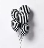 Bunch of big black and white with stripes balloons object for birthday party on gray