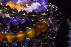 Bunch of semiprecious gemstone bracelets on black background - cornelian, amethyst, quartz royalty free stock photos Bunch of semiprecious gemstone bracelets on black background - cornelian, amethyst, quartz royalty free stock photos