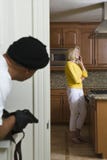 Burglar With Gun Peeking At Woman royalty free stock images Burglar With Gun Peeking At Woman royalty free stock images