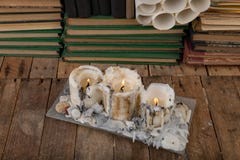 Burned candle on the background of old books. Desk of an old writer stock image Burned candle on the background of old books. Desk of an old writer stock image
