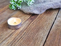 Burning candle on wooden table. stock photo Burning candle on wooden table. stock photo