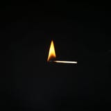 Burning match on a dark background . Cluse up royalty free stock image Burning match on a dark background . Cluse up royalty free stock image