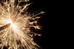 Sparkler in front of black background with copy space stock photos Sparkler in front of black background with copy space stock photos
