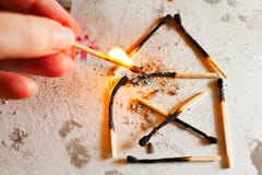 Burnt out family house after fire made of used matches - safety royalty free stock photo Burnt out family house after fire made of used matches - safety royalty free stock photo