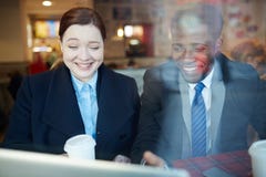 Business Colleagues Laughing Looking at Laptop Screen royalty free stock photos Business Colleagues Laughing Looking at Laptop Screen royalty free stock photos