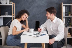 Business couple sitting and talking at modern office stock photos Business couple sitting and talking at modern office stock photos