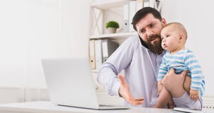Business dad working in office with baby son stock images Business dad working in office with baby son stock images