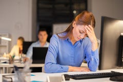 Businesswoman with computer at night office stock images Businesswoman with computer at night office stock images